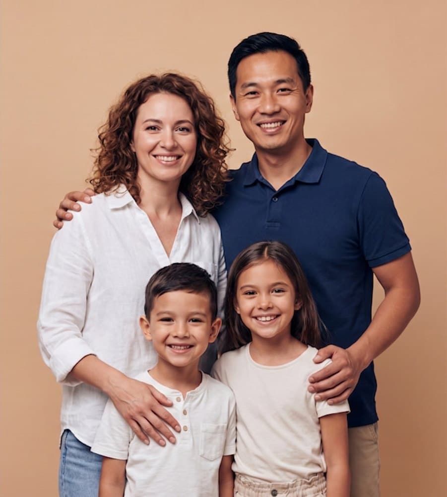 A family of four smiling together